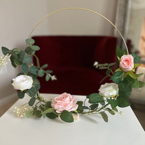 14” Hoop centerpiece, includes pink roses and green eucalyptus leaf garland. Can also special order rose color.