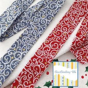 May include: Two rolls of bias binding fabric with a white background and a gold and red swirl pattern. The fabric is 2.5 inches wide and is ideal for adding a touch of elegance to your sewing projects.