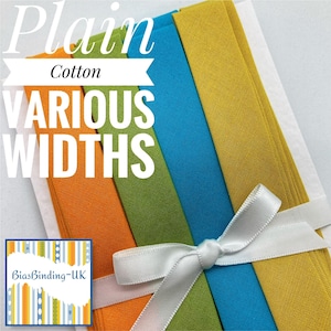 May include: A set of five plain cotton bias binding strips in various widths. The strips are in shades of yellow, orange, green, and blue. The strips are tied together with a white ribbon.