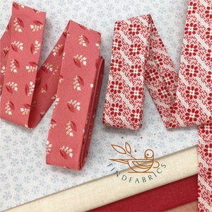 May include: Three red and white patterned fabric ribbons with a floral design. The ribbons are on a blue and white patterned fabric background. The text "FIND FABRICS" is visible in the lower centre of the image.