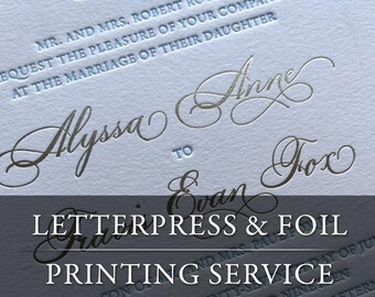 May include: A light blue wedding invitation card featuring silver foil calligraphy names Alyssa Anne and Evan Fox. The text includes Mr. and Mrs. Robert Royer request the pleasure of your company at the marriage of their daughter. The card has letterpress text.