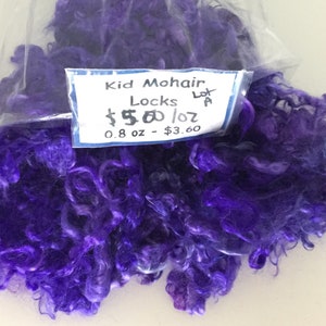 May include: A bag of purple kid mohair locks. The label reads "Kid Mohair Locks Lot # $5.00/oz 0.8 oz - $3.60".
