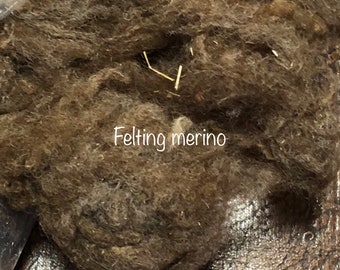 May include: Close-up of brown merino wool fibers for felting. The wool is soft and fluffy, perfect for creating handmade crafts.