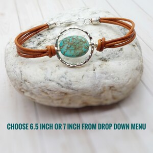 May include: A brown leather bracelet with a turquoise stone set in a silver circle. Choose 6.5 inch or 7 inch from the drop down menu.
