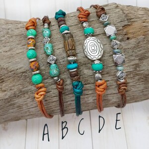 May include: Five leather bracelets with turquoise and brown beads, silver charms, and a variety of knots. The bracelets are labeled A through E.