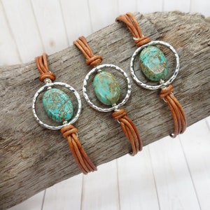 May include: Three brown leather bracelets with silver metal circles and turquoise oval stones.
