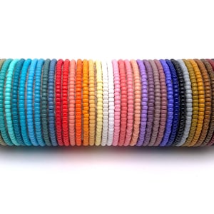 May include: A collection of colorful beaded bracelets in various shades of blue, green, red, orange, yellow, pink, purple, brown, and black.