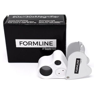 May include: A white and silver handheld magnifier with a 60x/30x magnification. The magnifier has three lenses and a push button to turn the LED light on and off. The box reads "60x/30xMagnifier" and "FORMLINE // Supply | LLC".