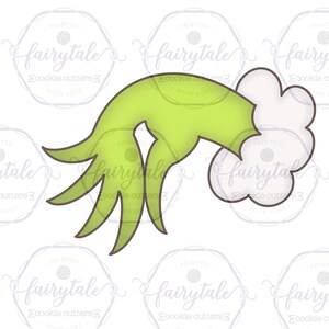 May include: Green hand cookie cutter with a white cloud coming out of the hand. The cookie cutter is designed to create a Grinch-themed cookie.