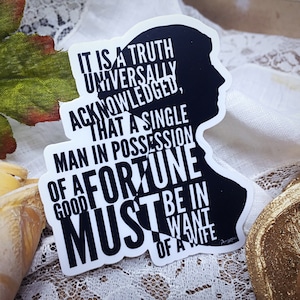 May include: A black and white sticker featuring a silhouette of a person's head and the text "IT IS A TRUTH UNIVERSALLY ACKNOWLEDGED, THAT A SINGLE MAN IN POSSESSION OF A FORTUNE MUST BE IN WANT OF A WIFE."
