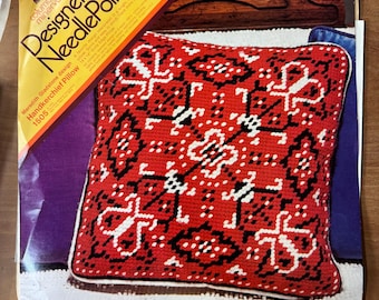 May include: A red and black needlepoint pillow with a geometric design. The pillow is labeled "Designer Needlepoint" and "Handkerchief Pillow 1505".