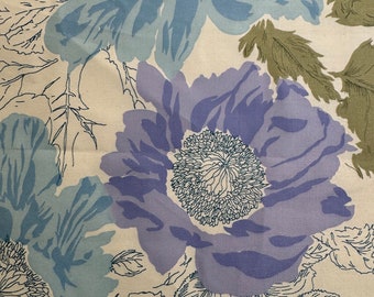 May include: A cream-colored fabric with a floral pattern. The flowers are blue, purple, and green. The fabric has a vintage feel.