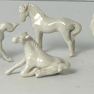 Vintage Chinese white porcelain horse figurines.