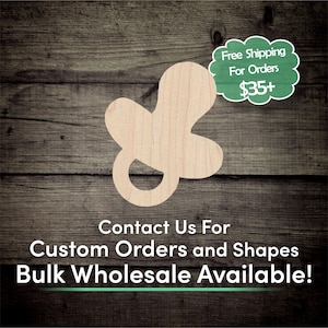 May include: A wooden cutout of a baby pacifier, painted in a light wood color. The cutout is on a brown wooden background. The text "Free Shipping For Orders $35+" is in a green speech bubble. The text "Contact Us For Custom Orders and Shapes Bulk Wholesale Available!" is in black text on a white background.