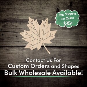 May include: A wooden maple leaf cutout with a natural wood finish. The leaf is on a wood background. The text "Free Shipping For Orders $35+" is in a green speech bubble. The text "Contact Us For Custom Orders and Shapes Bulk Wholesale Available!" is below the leaf.