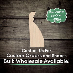 May include: A wooden cutout of a person's silhouette, standing against a woodgrain background. The text "Contact Us For Custom Orders and Shapes Bulk Wholesale Available!" is displayed below the cutout.