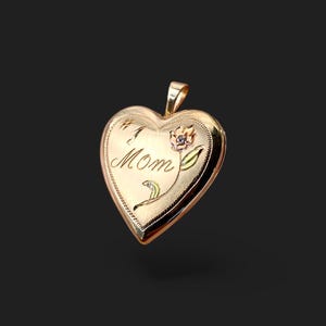 May include: Gold heart-shaped locket with a floral design and the inscription "I  MOM".