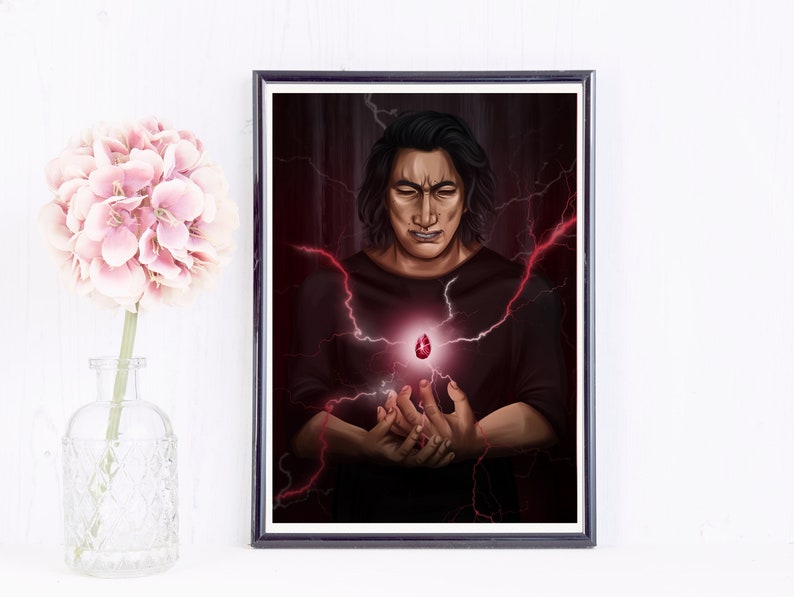 May include: Framed art print featuring a person with dark hair and a black shirt, holding a glowing red gem. Red lightning bolts emanate from the gem and surround the person, set against a dark red background.
