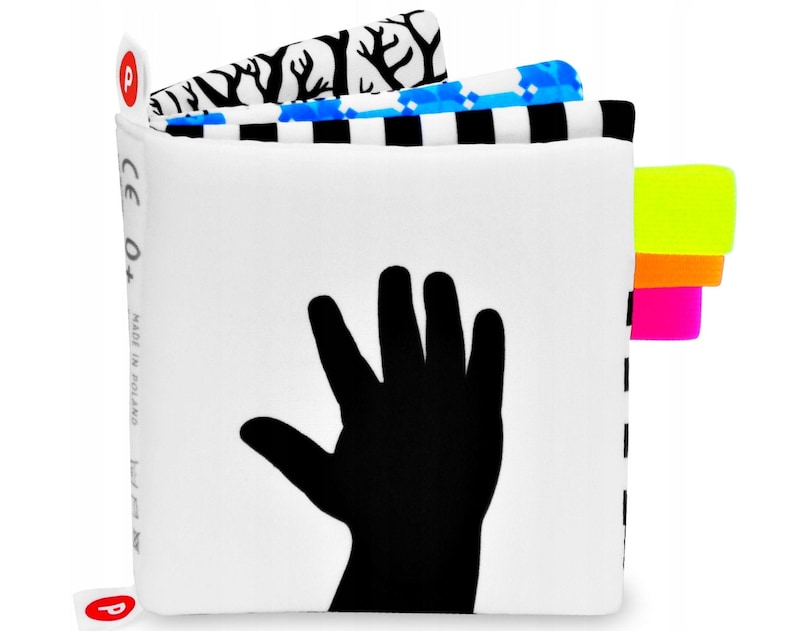 Contrasting silhouette of a baby's hand. The following pages show the same hand from the cover in strongly contrasting patterns, black and white and bright vivid colors. Each page has bright little tabs in neon colors.