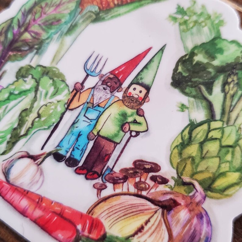 May include: Two gnomes with beards and red and green hats are standing in a garden. The gnome on the left is holding a pitchfork and the gnome on the right is holding a shovel. There are various vegetables and mushrooms in the background.