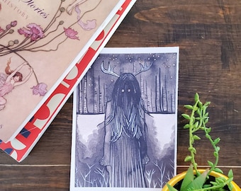 May include: A black and white illustration of a figure with antlers and long hair standing in a forest. The figure has large, dark eyes and is wearing a long, flowing robe. The background is a dark forest with tall trees and a starry sky.