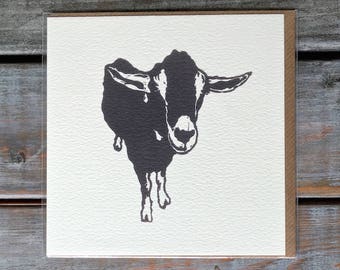 May include: A black and white illustration of a goat on a white card. The goat is looking directly at the viewer.