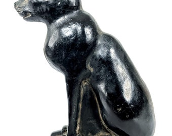 May include: Black Egyptian cat statue with hieroglyphics on the base.