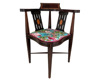 May include: A dark wood corner chair with a curved back and a seat upholstered in a pink flamingo print fabric.