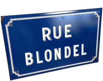 May include: A rectangular, blue street sign with white text that reads "RUE BLONDEL". The sign has a white border with decorative corner accents. The sign is made of metal and has mounting holes.