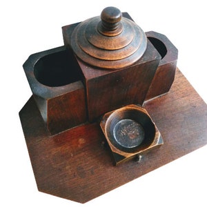 May include: A wooden box with four compartments, including a lidded compartment in the center. The box is made of dark wood with a natural finish.