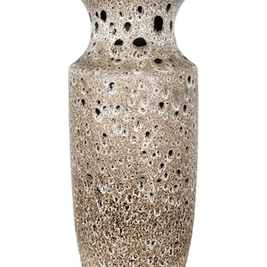 May include: A brown and white ceramic vase with a speckled glaze. The vase has a wide mouth and a narrow neck.