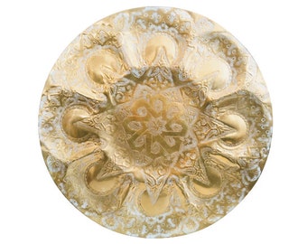 May include: A round, gold-colored metal tray with intricate embossed designs. The tray has a raised center and a scalloped edge.
