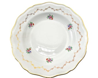 May include: A white porcelain soup bowl with a gold rim and floral pattern. The bowl has a scalloped edge and a delicate floral design in shades of pink, red, and blue.