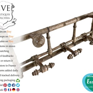 May include: An antique, weathered metal coat rack with multiple hooks and decorative finials. The rack has a distressed, aged appearance, suggesting it is vintage or reclaimed. The design includes horizontal bars and vertical supports, offering a rustic aesthetic.