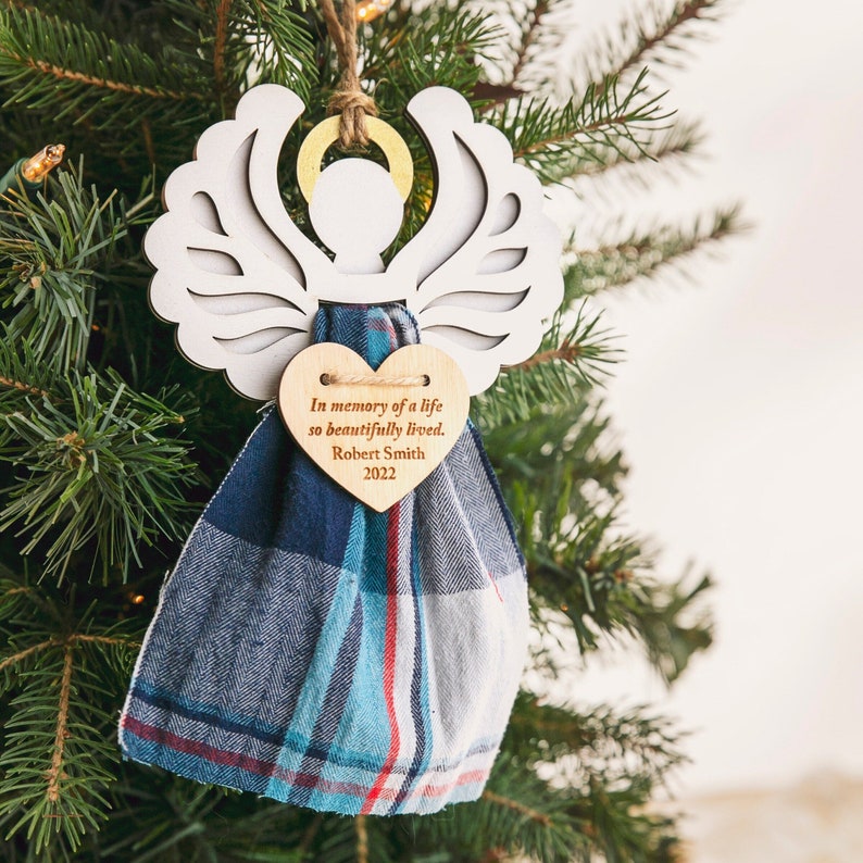 This is a personalized Angel Ornament crafted from a loved one's clothing, creating a cherished memory and keepsake for the Christmas tree. It's a touching remembrance item, especially for those who have experienced a loss.