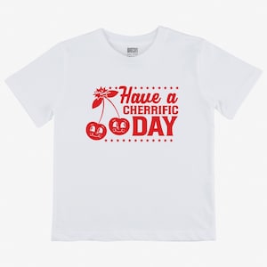 May include: White t-shirt with a red graphic of two cherries with faces and the text "Have a Cherrific Day"