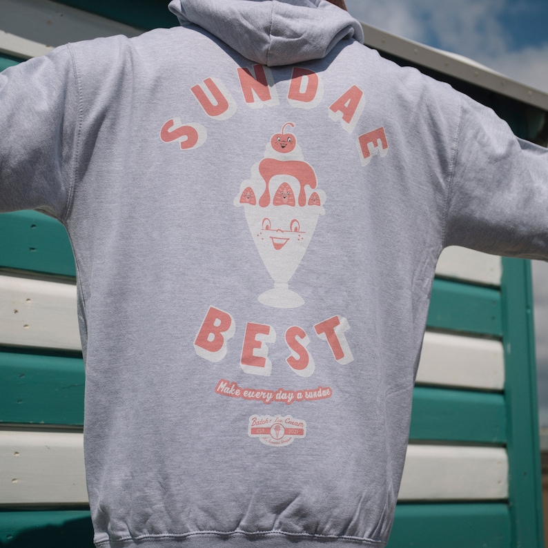 May include: Gray hoodie with a graphic of a sundae ice cream with the text "SUNDAE BEST" and "Make every day a sundae" below the graphic. The graphic also includes the text "Bob's Ice Cream" with a logo.