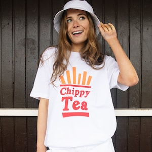 May include: White t-shirt with a red and orange graphic that says "Chippy Tea". The graphic features a stylized image of french fries.