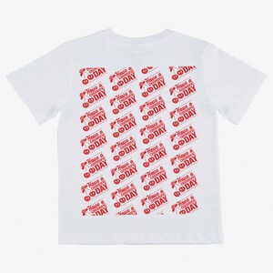 May include: White t-shirt with a red repeated pattern of cherries and the text "Have a Cherrific Day".
