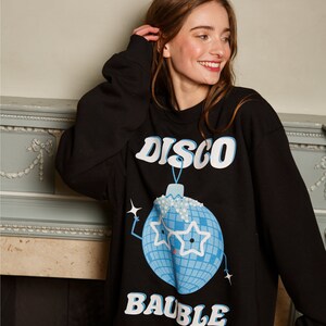 May include: Black sweatshirt with a blue disco ball ornament graphic and the text "DISCO BAUBLE".