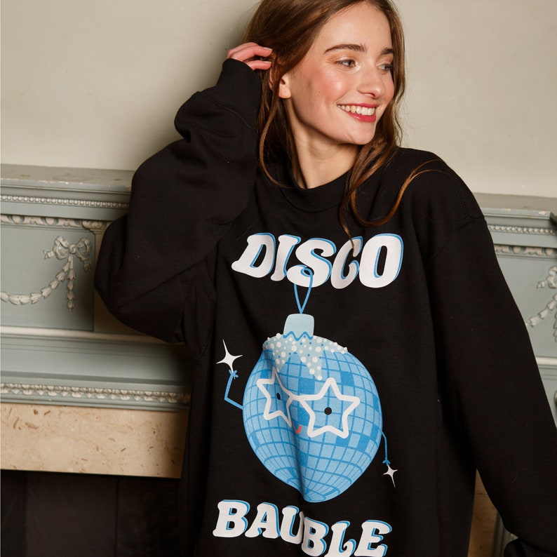 May include: Black sweatshirt with a blue disco ball ornament graphic and the text "DISCO BAUBLE".