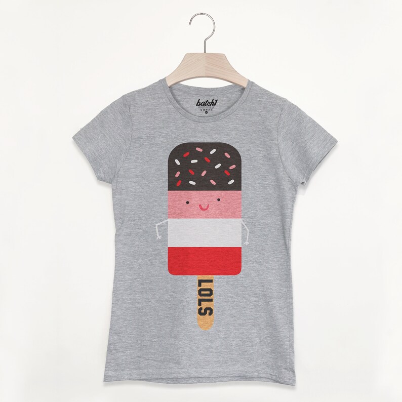 May include: Gray t-shirt with a graphic of a cartoon popsicle with a smiling face and the word "LOLS" on the stick.
