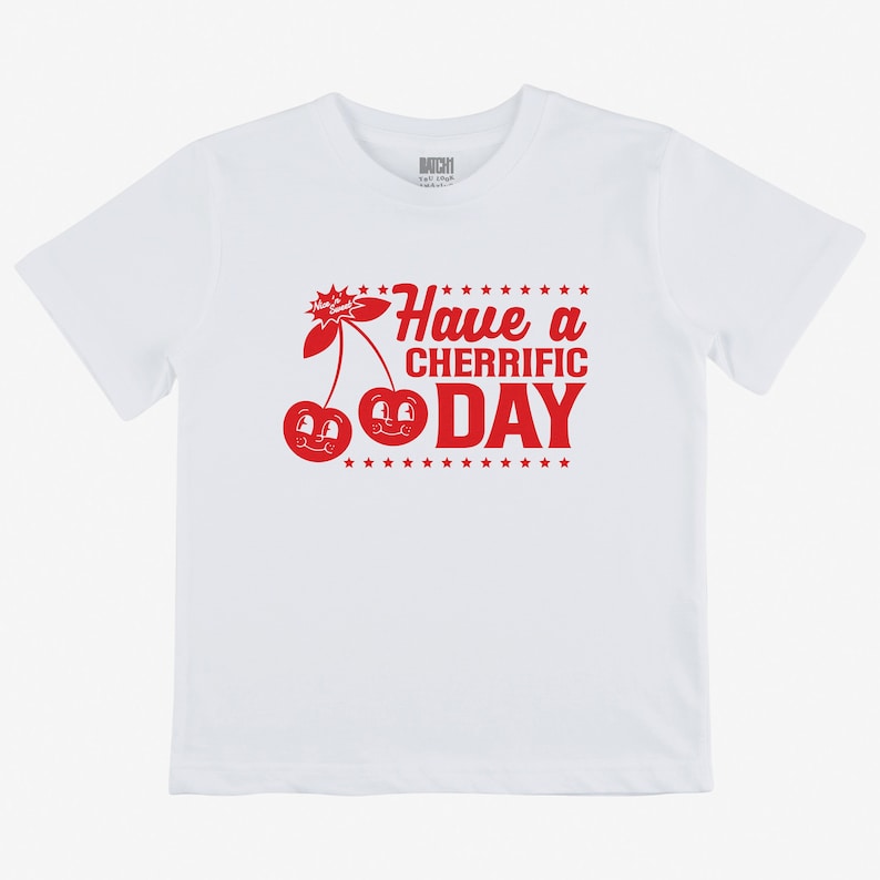 May include: White t-shirt with a red graphic of two cherries with faces and the text "Have a Cherrific Day"