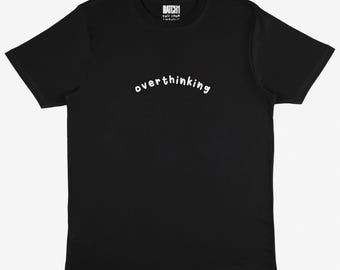 May include: Black t-shirt with white text that reads "overthinking" in a playful font.