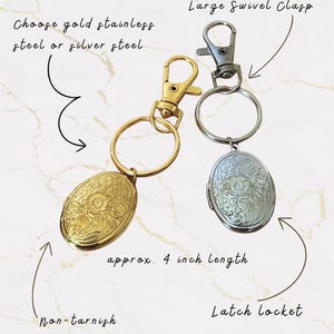May include: Two oval lockets with floral designs, one gold and one silver, attached to keychains with swivel clasps. The gold locket is non-tarnish. Each locket is approximately 4 inches in length.