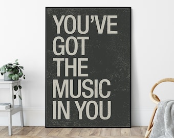 May include: A black and white poster with the text "You've got the music in you" printed in a vintage style font.