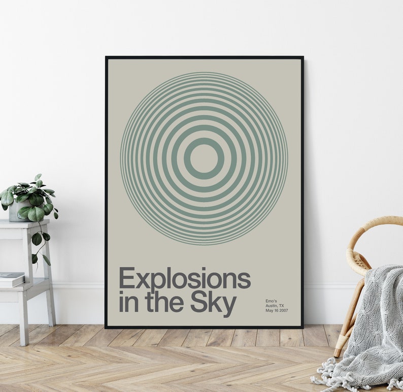 May include: A black framed poster with a light green concentric circle design. The text "Explosions in the Sky" is below the circle. The text "Emo's Austin, TX May 10, 2007" is in the bottom right corner.