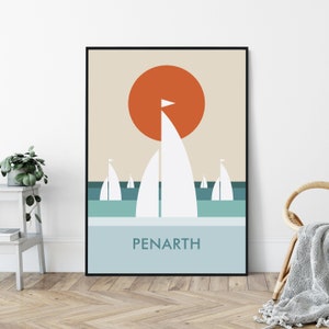 May include: A minimalist poster with a geometric design featuring a large orange sun and white sailboats on a blue and green ocean. The text "PENARTH" is printed in black at the bottom of the poster.