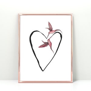 May include: Framed art print featuring a black heart outline with two pink hummingbirds inside. The birds have detailed wings and are in flight. The frame is a rose gold color, and the background is white.