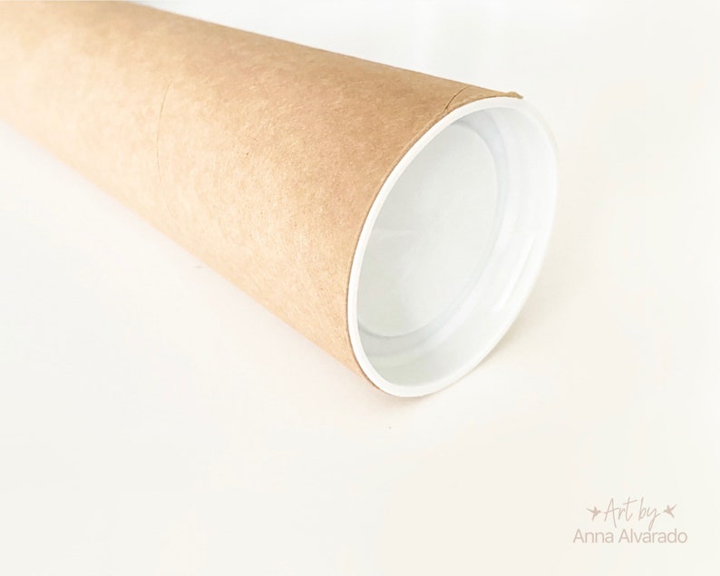May include: A rolled-up poster or print in a brown cardboard tube with a white interior. The tube is on a white surface. The text "Art by Anna Alvarado" is visible in the lower right corner.